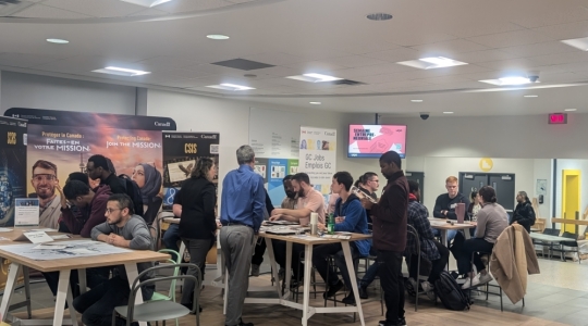 Les participants assis aux différents tables durant l'activité.